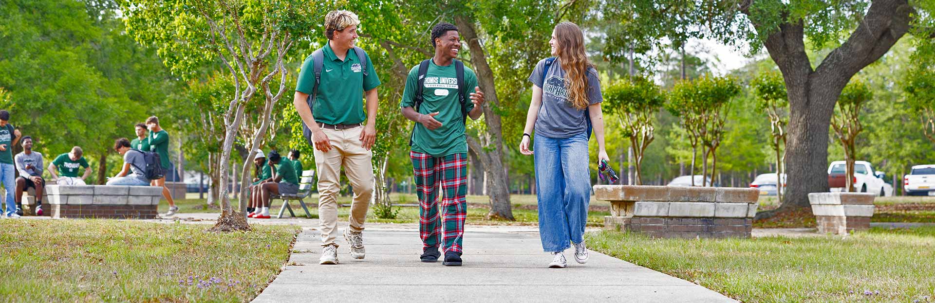 Two male and one female student walking at Thomas University's new Woodlands Campus