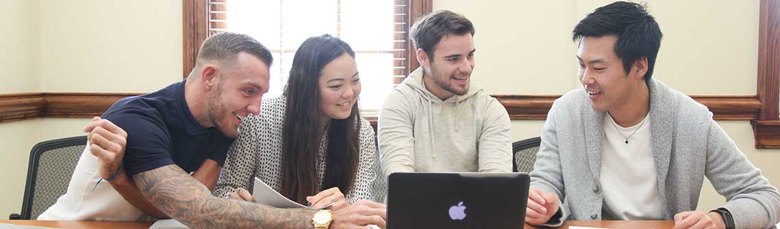 photo of Thomas University business students working on a group project